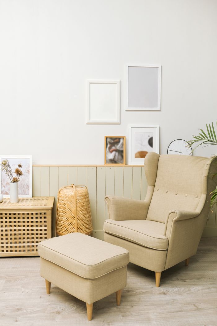 features-03 Cozy living room with beige armchair, pouf, and minimalist decor.